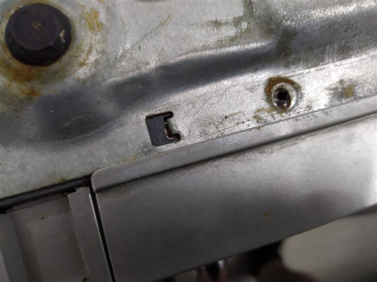 Plato de microondas no gira: detalle del clip y agujero de sujeción del motor en la chapa de la base